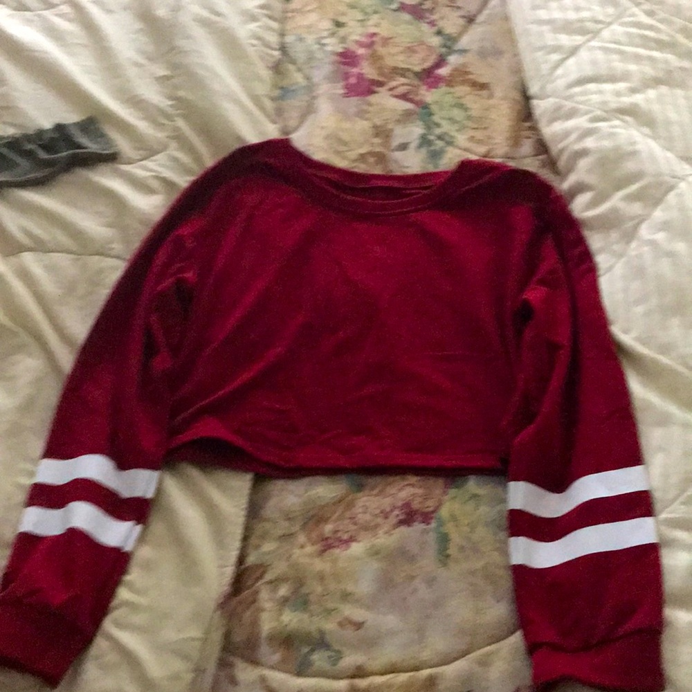 It’s is a cropped red long sleeve top